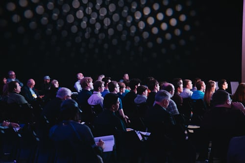 Audience attending an indoor presentation